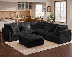 a living room filled with furniture and a large rug on top of a hard wood floor