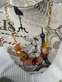 Agate beads with gold tone chain. Agate Beaded Chain Necklace With Round Beads, Gold Beaded Agate Necklaces, Elegant Amber Beaded Chain Necklace, Elegant Amber Necklace With Beaded Chain, Trendy Gold Necklaces With Gold Beads, Elegant Gold Carnelian Beaded Necklaces, Gold Agate Beaded Chain Necklace, Elegant Gold Carnelian Beaded Necklace, Gold Agate Beaded Necklace