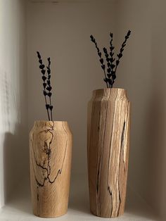 two wooden vases with plants in them