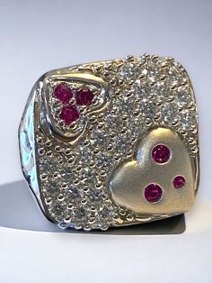 "Estate 14k White Gold BIG and BOLD 2 CTW Diamond Ruby Statement Heart Ring GORGEOUS! This beautiful vintage ring is sure to become a treasured heirloom! * Crafted with intricate detail, the beautiful large square face is a encrusted with beautiful round bright diamonds! * Ring face measures approximately 3/4\" across! * Round cut rubies are set into the hearts on face. * There are twenty nine (29) approximately .06 ct round diamonds set flush in this large square face ring! There are a total of Beautiful Rings Vintage, Face Ring, Round Diamond Setting, Square Face, Diamonds Ring, Square Faces, Multi Stone Ring, Vintage Ring, Multi Stone