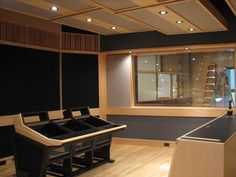 an empty conference room with black and white tables in front of a large window that looks out onto the street