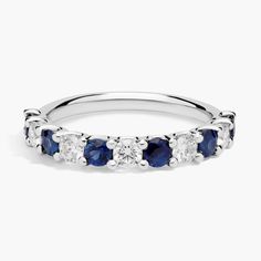 a white gold ring with blue sapphire stones