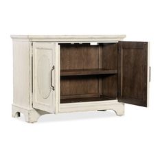 an old white cabinet with two doors open