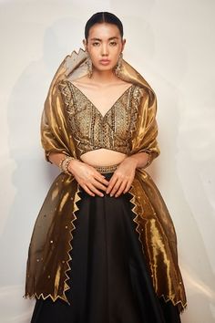 Black, gold attached cancan lehenga with cutdana, sequin embroidered border. Paired with sleeveless embroidered padded blouse and cutwork bordered dupatta. - Aza Fashions Silk Lehenga With Gold Embroidery For Party, Anarkali Style Gold Pre-draped Organza Saree, Gold Anarkali-style Pre-draped Saree Embellished, Gold Embellished Anarkali Pre-draped Saree, Gold Embellished Pre-draped Saree, Party Gold Raw Silk Choli, Party Dupatta With Gold Embroidery In Traditional Drape, Gold Embroidered Party Dupatta, Silk Choli With Gold Embroidery For Party