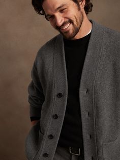 Made from a blend of extra fine Merino wool, this soft and warm cardigan is knitted in a subtly textured half-Milano stitch, which adds soft structure for refined appeal.  OVERSIZED FIT: Relaxed, boxy fit with a dropped shoulder.  Standard fit.  Long Mens Oversized Cardigan, Classic V-neck Soft Knit Outerwear, Classic Wool Ribbed Cardigan, Classic Ribbed Cashmere Outerwear, Classic Ribbed Wool Cardigan, Classic V-neck Sweater Coat For Layering, Classic Merino Wool Ribbed Outerwear, Wool Ribbed Outerwear For Work, Ribbed Wool Outerwear For Work