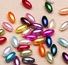 many different colors of glass beads on a table