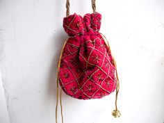 "Velvet evening purse with handwork of golden beads. Crossbody party bag with drawstring at the closure. It has an ethnic Indian touch in style and will go with western wears also like with dresses, jeans, etc. The bag is made up of velvet cloth in different color. It has a sling to hang it on the go. Can be used to gift some one or as fancy small sling bag in party or wedding. It can carry small things like mobile, wallet, etc. Dimension: maximum vertical length (of purse): 7\" vertical length Traditional Pink Shoulder Bag For Evening, Pink Bags For Evening And Festivals, Pink Shoulder Bag With Handwork For Party, Bollywood Style Embroidered Evening Potli Bag, Beaded Festival Clutch Bag, Beaded Clutch Bags For Festivals, Festival Beaded Clutch Bag, Bollywood Style Handwork Potli Bag For Party, Elegant Pink Shoulder Bag For Festivals