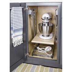 an open cabinet with a mixer and other kitchen accessories