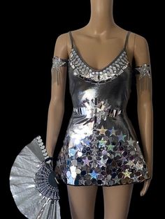 Mirror rhinestone rave festival skater dress.  Silver metallic with acrylic mirrors and sequins.   Umbrella, hand fan, feather mirrored boot wraps and star arm wraps.  Choose the full outfit or separate pieces.  Disco Rave festival outfit.  Made of high quality spandex fabric , acrylic mirrors and rhinestones.  Reflects when light hits it. Great for raves, music festivals, night clubs, social media and pictures. Star Festival Outfit, Stars Outfit Aesthetic, Disco Rave Outfit, Silver Concert Outfit, Space Rave Outfit, Metalic Outfits Ideas, Space Theme Outfit, Galactic Party Outfit, Star Outfit Aesthetic