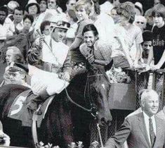 an old black and white photo of people riding on the backs of horses in a parade