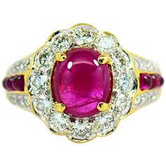 This Majestic natural Ruby ring with diamond halo is a real show stopper. Featuring a 2.42 carat rich red oval cabochon Ruby that scream with passion. The center ruby is set in four prongs surrounded by a diamond halo of 12 round brilliant diamonds. The beautiful bright red Ruby is full of life and is contrasted by the beautiful white brilliant diamonds on the halo. The scalloped design around the diamonds resembles a flower shape around the center ruby. The ring is masterfully crafted in 18k ye Cabochon Ruby, Natural Ruby Ring, Diamond Halo Ring, Ring With Diamond, Halo Diamond Ring, Vintage Jewels, Ruby Diamond, Halo Ring, Ruby Ring