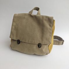 "Khaki Green Satchel Backpack, Backpack Purse, Canvas Rucksack, Vegan Eco Friendly Backpack, Laptop Backpacks, Retro Satchel Purse This lovely satchel backpack bag is a classic and nostalgic one. The bag closes with 2 front bronze clips which integrate beautifully with the fabric colors. The Satchel Backpack can serve you to work, college and even as a diaper bag. it is unique and 100% vegan! ** SPECIFICATIONS ** Features: + Wide adjustable shoulders straps to fit any height. + One internal pock Khaki Satchel Backpack With Large Capacity, Beige Satchel Leather Backpack For Back To School, Khaki Canvas Satchel For School, Beige Leather Satchel Backpack For Back To School, Beige Rectangular Backpack For Back To School, Beige Canvas Satchel Backpack, Beige Softback Backpack For Outdoor, Back To School Canvas Shoulder Backpack, Canvas Satchel Backpack With Removable Pouch