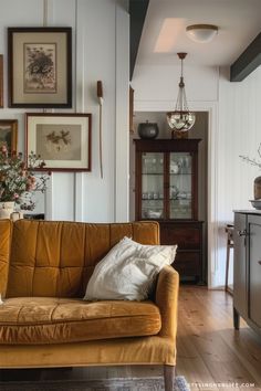 a living room filled with furniture and pictures on the wall