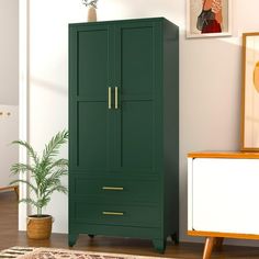 a green armoire next to a white dresser and potted plant in a room