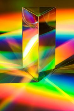 an abstract image of two cubes in the middle of a multicolored background