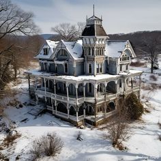 an old house with snow on the ground and trees in the foreground, from above