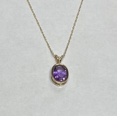 14 Karat Yellow Gold Genuine Amethyst Oval 8mm x 6mm Pendant w/18" Chain Brand new item Crafted of solid 14 karat yellow gold (weighs 1.10 grams) Genuine Amethyst (8mm x 6mm, weighs 1.05 carats) Oval, bezel-set gemstone 14K yellow gold 18" loose rope chain included Ring clasp Marked 14K Gift Boxed SKU: BF Elegant Oval Amethyst Pendant Jewelry, Purple Gemstone Necklace With Oval Pendant, Gold Amethyst Oval Cabochon Jewelry, Purple Amethyst Oval Pendant Jewelry, Hallmarked Amethyst Oval Pendant, Rope Chain, Fine Jewellery Necklace, Bezel Setting, Gemstone Ring