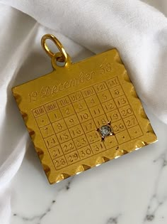 Vintage 14K Yellow Gold DIAMOND December 25th 1958 Date Calendar Charm Pendant! AMAZING Custom vintage charm! * This charm is square in shape, measuring approximately 1" with bale x 3/4" and has "19 DECEMBER 58" written at the top and numbers on all of date squares with a genuine diamond on December 25th! * Back inscribed "To Margie, From Mary". sold as in original condition, but could be polished off by your local jeweler! * Hallmarked 14K  * Weighs 2.4 grams Ships FAST and FREE, fully insured Date Squares, Vintage Gold Watch, 19 December, Gold Watches Women, Bling Earrings, Vintage Fine Jewelry, Date Calendar, Bling Rings, Sentimental Gifts