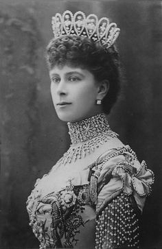 an old black and white photo of a woman wearing a tiara