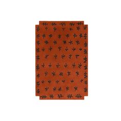 an orange napkin with black flowers on it