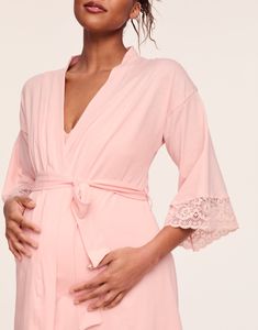 Elegant, lace trimmed kimono sleeves will make this your prettiest maternity and nursing robe. Pair it with the matching Rachelle Robe for an luxe set. Lace trimmed kimono sleeve Ample coverage to cover the bump Designed for pregnancy or after baby Knee length Soft rayon / spandex knit Nylon / spandex lace V-neck Lace Trim Robe For Daywear, Spring Robe With Lace Trim For Loungewear, Feminine Fitted Robe With Lace Trim, Fitted Feminine Robe With Lace Trim, Feminine Long Sleeve Kimono For Loungewear, Lace Trim V-neck Robe For Daywear, V-neck Robe With Lace Trim For Daywear, Feminine Lace Trim Robe For Loungewear, Feminine Fitted Robe For Loungewear