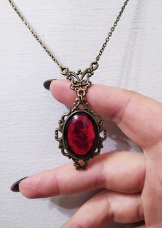 ◆ Victorian style necklace. The red blood cabochon size is 0.984252 x 0.708661 inches and it was completely handmade in resin. The inserts, the base and the chain are in bronze, The product is made by hand with great care. ♡ In my shop there are many handmade jewelry for all tastes, come and watch them are welcome! ♡ Bloodstone Jewelry Necklaces, Red Stone Pendant, Red Stone Necklace, Goth Things, Witch Necklace, Blood Stone, Victorian Necklace, Victorian Pendants, Red Pendants