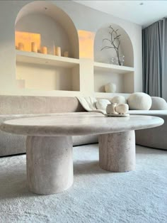 a living room filled with furniture and white carpeted flooring next to a window