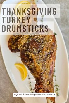 thanksgiving turkey drumsticks on a plate with lemon wedges