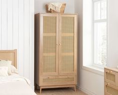 a bedroom scene with focus on the armoire and bed