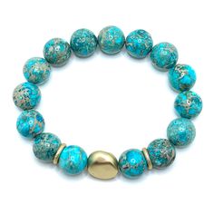 Turquoise Aqua Terra Jasper Matte Gold Nugget Stretch Bracelet Measures One Size Fits Most Made In The USA Style Number DB748 Turquoise Amazonite Round Bracelets, Turquoise Agate Bracelet, Adjustable Turquoise Stretch Bracelet With Natural Stones, Turquoise Gemstone Bracelets With Round Beads, Adjustable Jasper Jewelry In Turquoise, Turquoise Stretch Bracelet With Natural Stones For Healing, Turquoise Natural Stones Stretch Bracelet For Healing, Turquoise Amazonite Bead Jewelry, Turquoise Stretch Bracelet With Natural Stones As Gift