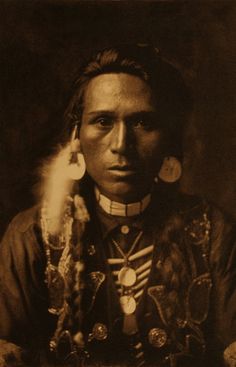 an old black and white photo of a native american woman