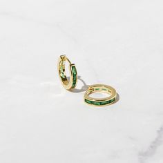 Beautifully crafted baguette style emerald huggies. Looks so elegant! Features baguette stones on both front and back sides. - - - D E T A I L S - - - * Made of 925 Sterling Silver * Inner Diameter: 9 mm * Outer Diameter: 11 mm * Available in 14k Gold or Rhodium plated over 925 Sterling Silver * We use a thick plating for a piece that will be with you for years to come * SOLD AS A PAIR * Thickness: 2.5mm * Nickel-Free and Hypoallergenic Made with 100% Pure Love ♡ Happy to answer any questions yo Luxury Small Hoop Green Earrings, Layering Diamond Necklaces, Earrings Emerald, Small Hoop Earrings, May Birthstone, Emerald Earrings, Huggie Earrings, Emerald Jewelry, Stunning Earrings