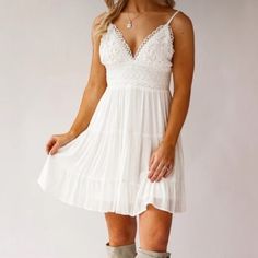 Charm every heart with the Joliet Tiered Mini Sundress. A delicate ivory white embroidered country boho day dress. It features adjustable straps, tie back detail, tiered ruffle skirt and a peekaboo back.  the perfect come and go dress for brunch dates,  warm days at the vineyard and farmer's market, country music concerts and romantic dates.  -Rayon/Polyester. -Elastic Waist.  -Dry Clean. -Fits True to Size -V-Neck -Sleeveless  -Adjustable Straps - unlined, semi sheer -Crochet Top -Self Tie At B Country White Dress, Cowgirl Crochet, Engagement Photoshoot Outfit, White Lace Sundress, Country Dress, Nashville Outfit, Lace Sundress, Clean Fits, Country Bride