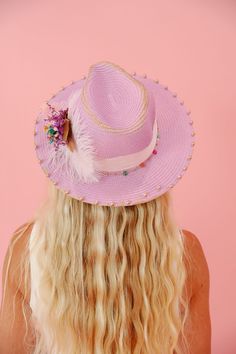 Introducing THE KATE SUN HAT - the perfect as purple as the inside of a grape, with touches of gold, pink ribbon, and soft white feathers, this sun hat brings all the colors of spring together in a quirky, stylish manner! Say "hello" to sunny days with this statement piece. This hat is ONE OF A KIND, created by our owner Stephanie. To receive item quicker, expedited shipping is available at checkout. Pink Flat Brim Fedora For Spring, Playful Pink Mini Hat For Summer, Pink Summer Festival Hats, Pink Short Brim Fedora For Spring, Pink Hat For Kentucky Derby Festival, Whimsical Straw Hat For Spring Vacation, Bohemian Pink Hat For Spring, Whimsical Straw Hat For Beach In Spring, Whimsical Straw Hat For Spring Beach Outings