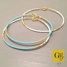 three bracelets with gold and blue beads