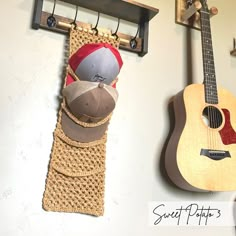 there is a hat and guitar hanging on the wall