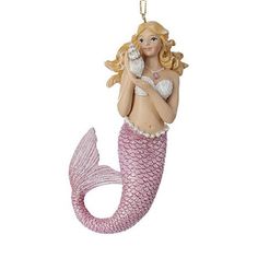 a christmas ornament shaped like a mermaid holding a seashell in her hand