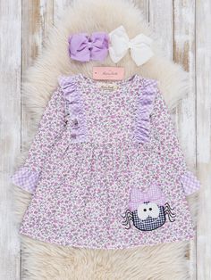 This dress will leave you stuck in it's web! This vintage floral dress features a sassy spider appliqué with purple gingham ruffles. Fits true to size. 95% Polyester / 5% Spandex Accessories sold separately. Add $3.50 for the 5" two layer bow. Suggest bow color #1 or #58 Import. *Afterpay and Sezzle Purchase Requires $35 Minimum Order. Toddler Girl Halloween, Purple Gingham, Xxxl Dress, Vintage Floral Dress, Dresses Xxl, Purple Dress, Xl Dress, Ruffle Dress, Dresses Xs