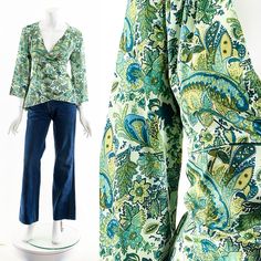 "y2k emerald green paisley boho blouse plunging neckline 3/4 length bell sleeves faux wrap front gathering along shoulder yoke Fits like: small-medium Material: Polyester Spandex Condition: Great Clipped on Mannequin: No ✂ SIZE + FIT ✂ Length: 24\" / 61 cm Shoulders, seam to seam: 17\" / 86 cm Sleeve Length: 19\" / 97 cm Bust: 40\" / 51 cm Waist: 35\" / 44 cm All measurements are taken with garment lying flat. ALWAYS refer to measurements as vintage sizes run can vary greatly from today's modern Vintage Stretch V-neck Top, Vintage Printed V-neck Top, Green V-neck Hippie Top, Vintage Cotton V-neck Blouse, Spring V-neck Paisley Print Tops, Bohemian Blouse With Vintage Print For Spring, Vintage V-neck Top With Boho Print, Green 3/4 Sleeve Blouse For Fall, Fitted Boho Print Blouse For Spring