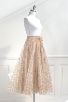 A feminine wardrobe day-to-night staple, this taupe polka dot tulle midi skirt is a classic, timeless style. Cut for a flattering, a-line silhouette with an elastic waistline for a comfortable fit, it's perfect for a romantic evening or an everyday feminine look. The romantic and airy tulle is simply made for twirling! . Details: S: Waist 24"-29", Length 35" M: Waist 26"-31", Length 36" L: Waist 28"-33", Length 37" XL: Waist 30"-35", Length 38" Lining Length: 29" Elastic Waistline Lined Material Feminine Skirts, Feminine Skirt, Feminine Wardrobe, Tulle Midi Skirt, French Girl Style, Romantic Evening, Romantic Dress, Easter Dress, Feminine Look