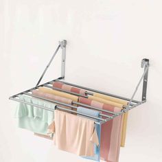 an over the door drying rack with towels hanging from it's sides and clothes on top