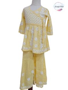 This is  super soft hand-embroidered chikankari angarakha style Kurti, sharara set for your little ones. It gives a very smooth feel to your skin and hand embroidery on this Kurti makes it set apart from other Kurtis. It is a premium quality fabric with hand work all over the set. TOP Fabric - Premium Modal Neck Type: Round Neck BOTTOM FABRIC- Modal with hand embroidery  Please note : DUPATTA is  NOT included. Please check measurements to ensure fitting. Size - 1) 2-3 year (size 18) Kurti length: 17.5 inches approx  Sharara length: 19.5 inches approx Chest: 20 inches approx 2) 5-6 year (size 26) Kurti length: 26 inches approx  Sharara length: 25 inches approx Chest: 28 inches approx 3) 8-9 year (size 30) Kurti length: 28.5 inches approx  Sharara length: 29 inches approx Chest: 30 inches ap Bollywood Style Sharara With Cutdana For Spring, Cotton Sharara With Resham Embroidery For Spring, Traditional Spring Sharara With Dori Work, Spring Cotton Sharara With Zari Work, Cotton Sharara With Floral Embroidery For Diwali, Anarkali Sharara With Cutdana For Spring, Spring Anarkali Sharara With Cutdana, Yellow Sharara With Chikankari Embroidery For Spring, Traditional Cotton Sharara With Floral Embroidery