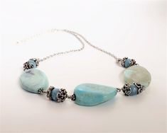 "This is a Blue agate necklace, Aquamarine stone, healing necklace, Blue stone, gemstone necklace, Appealing jewelry, gem stone necklace, gift idea for her. Material : Genuine gemstone, metal beads, silver tone metal chains. Length: adjustable 44cm to 46cm (17\" to 19\") weight : 35.2g (1.24oz) The detail of the gemstone are Blue agate nugget shape around 30mm x3, Aquamarine round 8mm x4, metal beads. CumisGems Chain necklace https://www.etsy.com/jp/shop/CumisGems?section_id=19407562 All CumisGe Amazonite Gemstone Necklaces For Jewelry Making, Gift Turquoise Long Necklace With Natural Stones, Gift Long Turquoise Necklace With Natural Stones, Blue Necklaces With Natural Stones For Gift, Blue Amazonite Necklaces For Jewelry Making, Gift Necklace With Natural Stones And Chalcedony, Chalcedony Necklace With Natural Stones For Gift, Amazonite Gemstone Beads Necklace For Gift, Light Blue Gemstone Beaded Necklace Gift