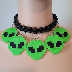 These kandi necklaces are made with pony beads and alien charms. One size fits all. This Item adjust up to 17 Inches.  This Item is made to order. Perfect for any event! You will get lots of compliments in this unique wearable art! Stand out at your next event! Edm festival  Raves Party  Rave outfit  Festival outfit Pride Handmade Adjustable Choker For Cosplay, Adjustable Black Rave Style Choker, Adjustable Black Rave Choker, Rave Jewelry For Halloween Party, Handmade Emo Jewelry For Festivals, Black Rave Style Choker Jewelry, Adjustable Rave Style Choker, Adjustable Rave Choker For Festival, Handmade Rave Jewelry For Party