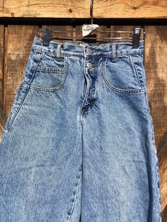 "Vintage Guess High waisted jeans.  Made in USA. Sz 27. Light acid wash. Back pocket has small hole. 2 buttons and zipper closure. Waist-12\" length-37\"" Light Wash Jeans With Button Closure, High Rise Light Wash Jeans With Button Zip Fly, High Rise Washed Blue Jeans With Button Closure, Trendy Medium Wash Jeans With Button Zip Fly, Light Wash Straight Leg Jeans With Button Zip Fly, High Rise Light Wash Jeans With Button Closure, High Rise Flare Denim Jeans, High Rise Flare Jeans With Button Zip Fly, High-rise Flare Denim Jeans With Button Zip Fly