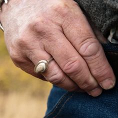 a man's hand with a ring on it