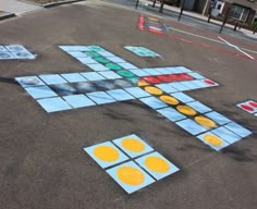 an image of a game being played in the street with blocks and circles painted on it