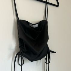 Satin Black Crop Top Perfect For Going Out! The Straps And Waist Are Adjustable In Length Through The Side Tie Closure. Never Worn, Nwot. Small Pinpoint White Marking, Shown In Pictures. Haven’t Tried Washing It Out But It’s Barely Noticeable. Bundle And Save! Chic Black Top With Drawstring, Black Tops With Drawstring For Night Out, Black Drawstring Tops For Summer, Summer Black Party Tops, Summer Party Black Top, Elegant Black Crop Top For Beach, Black Crop Top For The Beach, Black Y2k Top For Beach, Black Tie-back Top For Beach