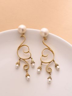 ♥ Dangling brass long earring ♥ Ethnic Pearl danglers in bohemian style, Tear drop pearls set in a curvy design. 18K Gold plated brass earrings. These danglers are super chic, versatile, light weight and hassle free. What makes it different in terms of design is the texture technique which is exclusively hand made. Grab these beauties !! WHY - YOU'LL - LOVE - IT * It's dainty and can be worn every day * A special piece you'll treasure * High-quality materials and attention to detail ~Made with L Bohemian Danglers For Wedding, Elegant Gold Hoop Earrings With Latkans, Elegant Pearl Drop Hoop Earrings For Festive Occasions, Elegant Pearl Earrings With Latkans For Formal Events, Elegant Festive Hoop Earrings With Latkans, Elegant Formal Bridal Earrings With Latkans, Elegant Bridal Earrings With Latkans For Formal Occasions, Elegant Metal Danglers For Festive Occasions, Elegant Clip-on Earrings With Latkans