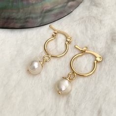 Small Hoop Earrings With Pearl Charm, Gold Huggie Earrings With Pearl Charm, 14k Gold-filled Huggie Hoop Earrings With Pearl Charm, Small Hoop 14k Gold Filled Pearl Earrings, Gold 14k Gold Filled Huggie Earrings With Pearl Drop, Gold Minimalist Huggie Earrings With Pearl Drop, Delicate Small Hoop Huggie Earrings, Dainty Huggie Pearl Earrings With Charm, Dainty Small Hoop Huggie Earrings With Pearl Charm